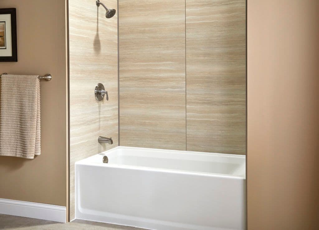 A bright shower with a white tub and a wall covered with wood.